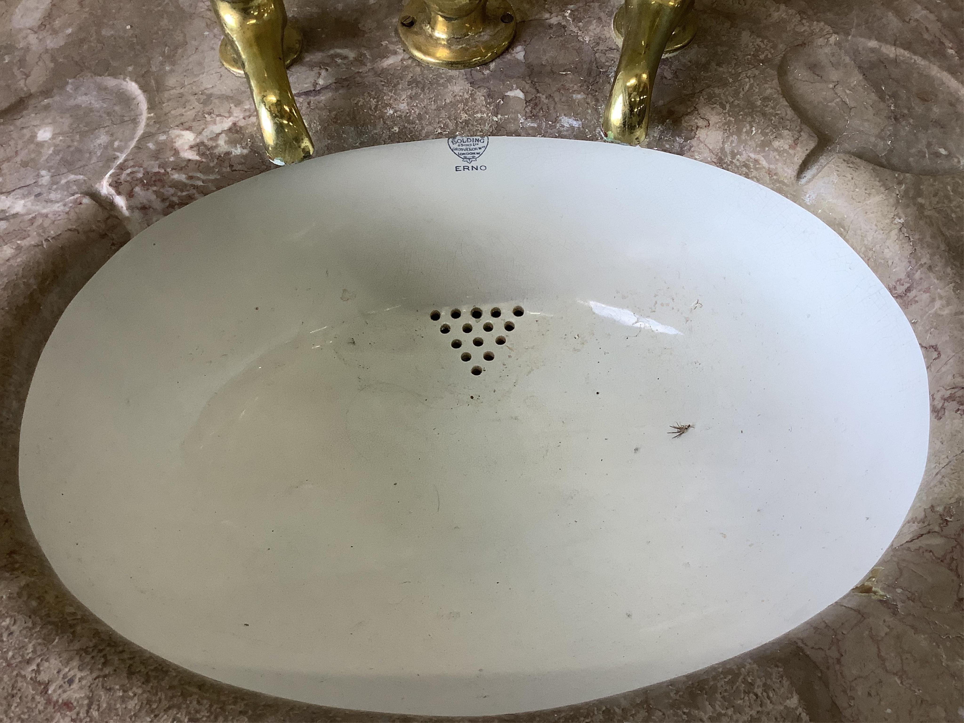 A marbled topped mahogany wash basin with John Bolding & Sons Erno ceramic basin and brass metal work, width 69cm, height 117cm. Condition - two old repair cracks to the marble top near front right, otherwise fair